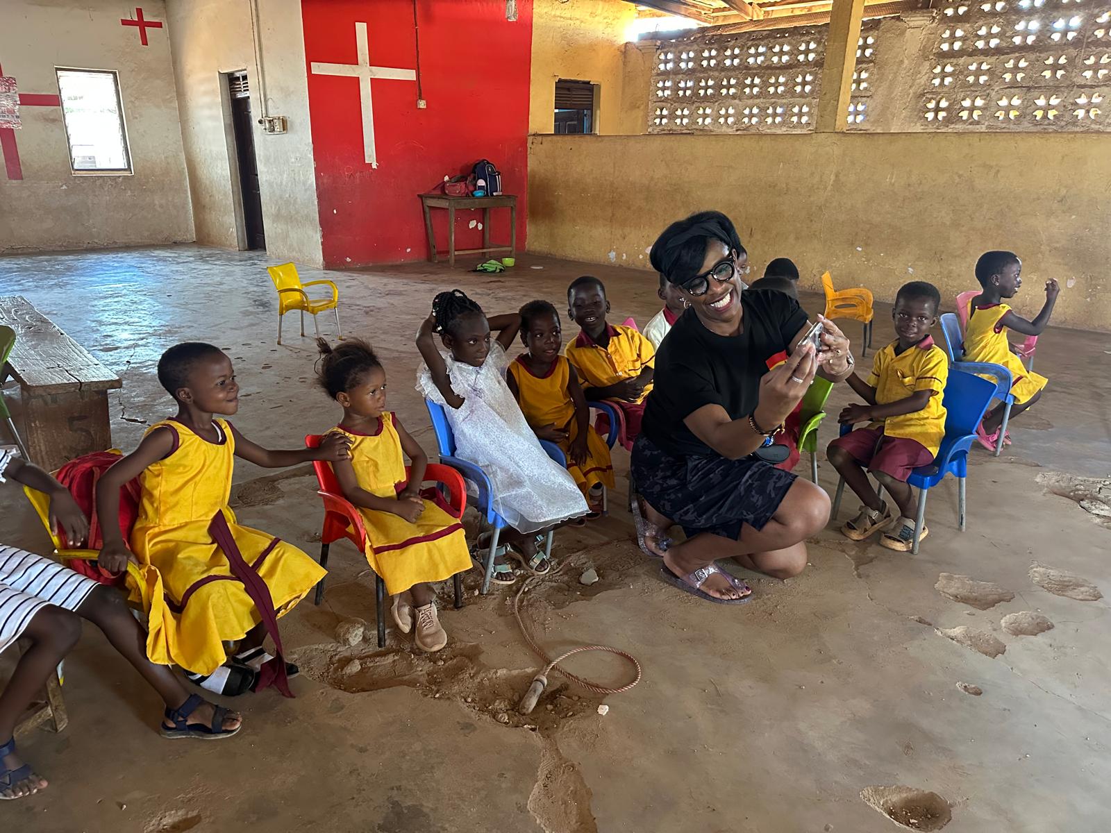 Dr Cooper connecting with children in Ghana