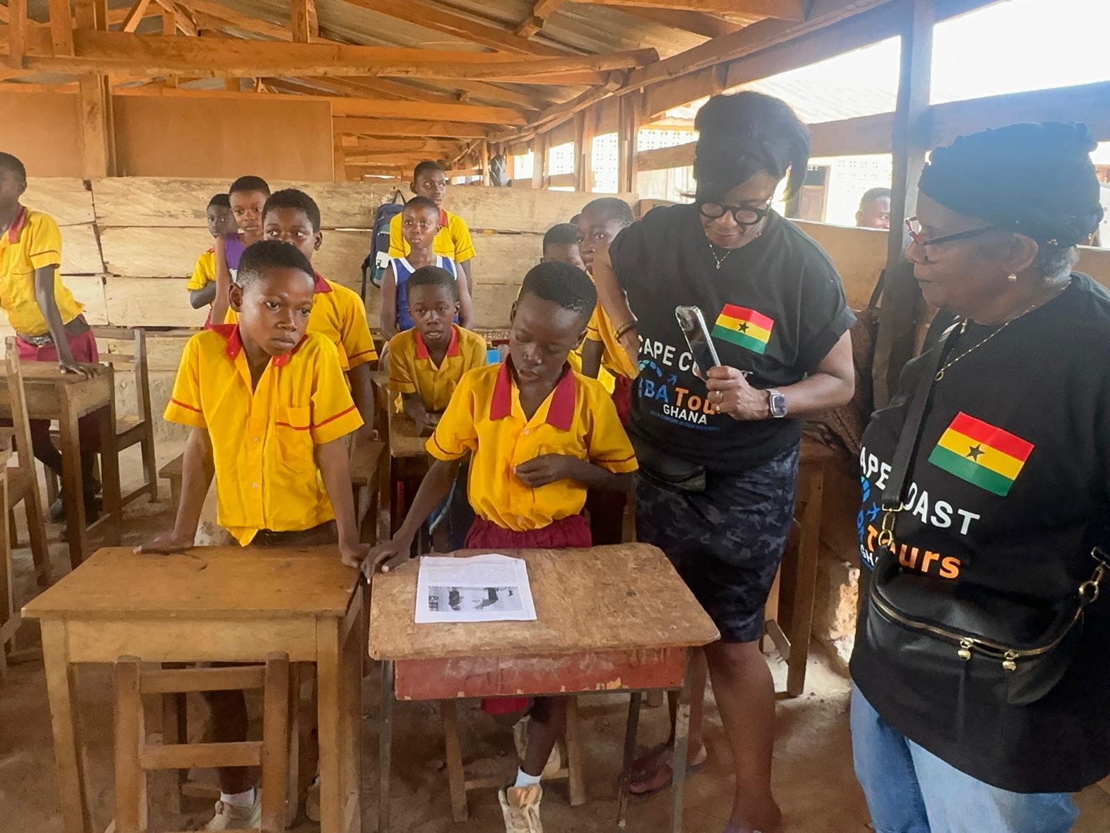 Dr Cooper reviewing materials with students Ghana